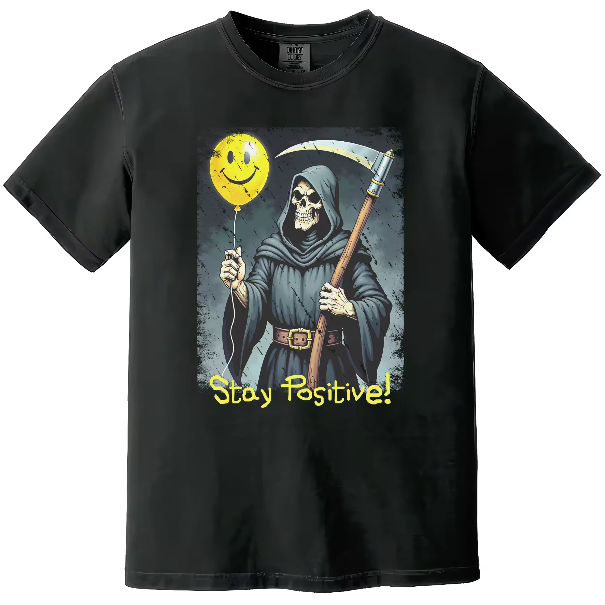 Black “Stay Positive” grim reaper t-shirt flat lay featuring scythe and yellow smiley face balloon, sarcastic dark humor graphic design