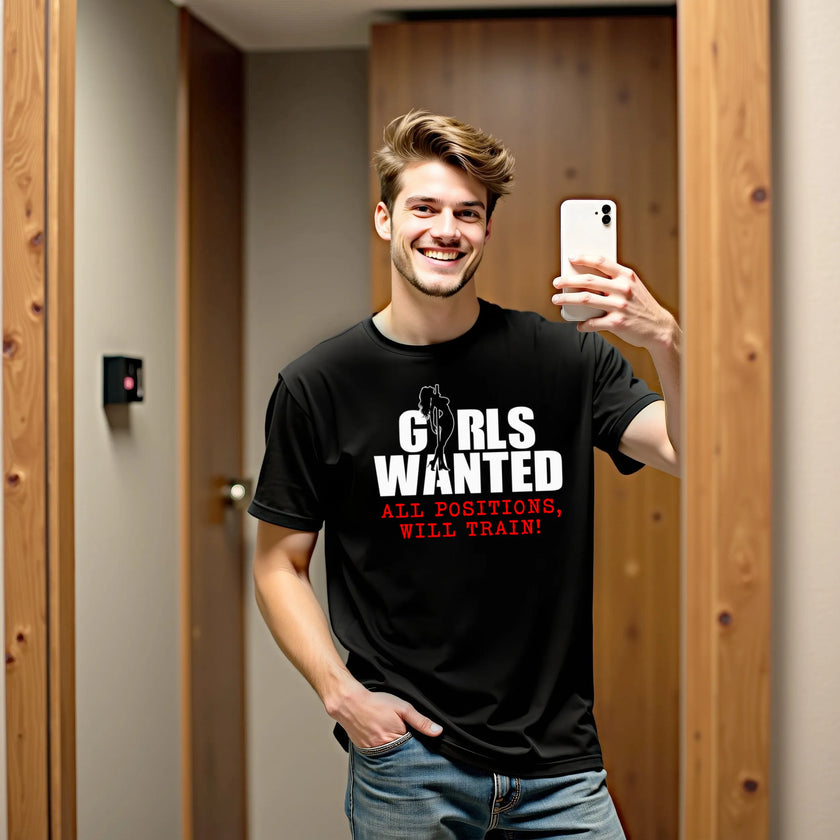 Male model wearing black ‘Girls Wanted All Positions’ t-shirt outdoors, sign-style graphic with silhouette detail, bold party night vibe.