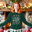 Female model wearing green funny New Year ugly sweater sweatshirt featuring ‘Glad This F*cking Year Is Over’ knitted-look lettering with champagne bottle, reindeer, and festive stars.