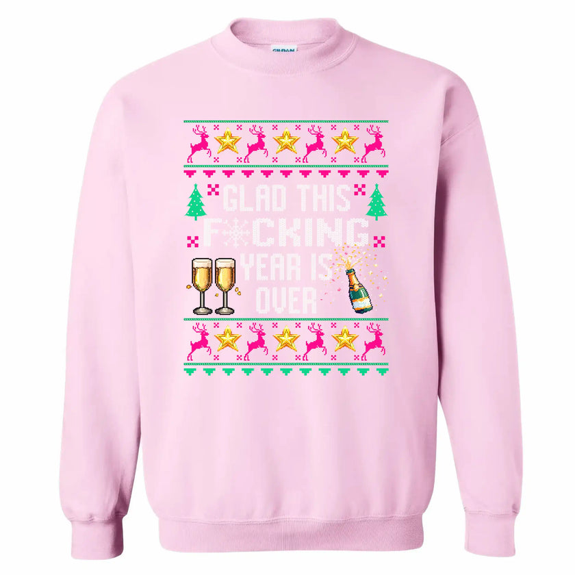 Pink sarcastic New Year ugly sweater sweatshirt featuring ‘Glad This F*cking Year Is Over’ knitted-style text with champagne bottle, reindeer, and playful festive stars