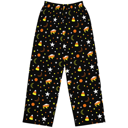 Flat lay of black Buffalo Halloween lounge pants featuring unique candy corn themed pattern with orange yellow white buffaloes, candy corns, stars, moons, and dots.