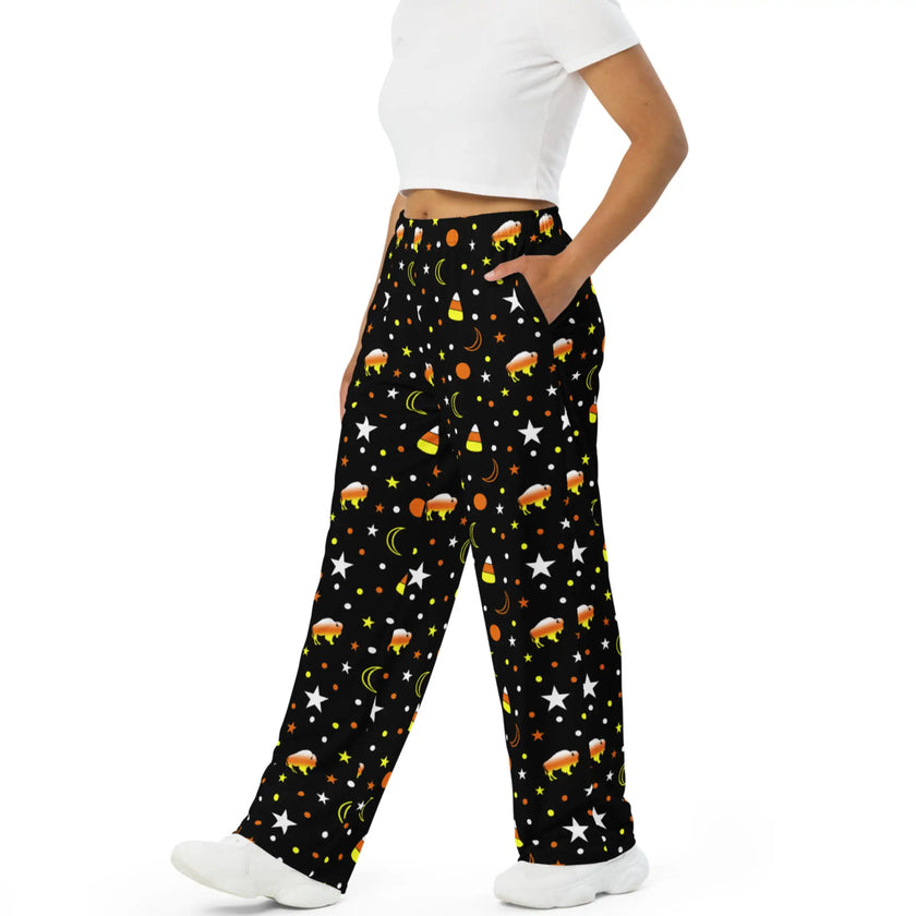 Side view of black Buffalo Halloween lounge pants showcasing playful all-over print with candy corn colored buffalo silhouettes, stars, moons, and seasonal details.