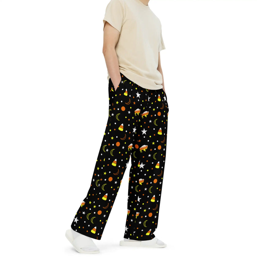 Right side view of black Halloween Buffalo lounge pants displaying orange yellow and white buffalo silhouettes with candy corn graphics and whimsical spooky accents.