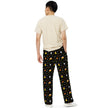 From behind, a pair of unisex Buffalo Halloween pajama pants with black background and repeating candy corn inspired design featuring colorful buffalo silhouettes, candy corns, stars, and moons.