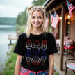 Female model wearing black patriotic ice cream t-shirt, six popsicles in red white blue gradient outline design, festive 4th of July summer outfit.