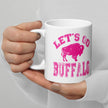 Hand holding white ceramic coffee mug featuring hot pink distressed ‘Lets Go Buffalo’ Buffalo football design with buffalo silhouette, game day drinkware.