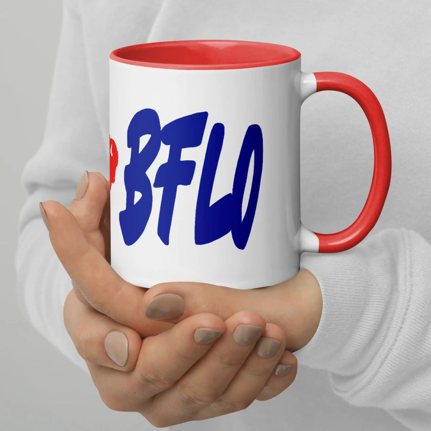 Hand holding white ceramic coffee mug featuring Buffalo football ‘LFG BFLO’ design with bold blue lettering and red buffalo silhouette, game day drinkware.