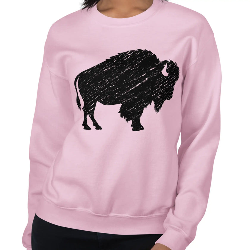 Woman wearing a light pink Buffalo pride sweatshirt featuring a large black distressed buffalo graphic, pretty casual style inspired by Buffalo NY.