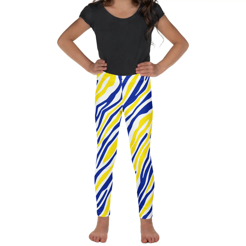 Child posing in blue and gold Buffalo hockey leggings, showing the flexible fit and eye-catching stripe pattern designed for active little fans.