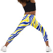 Child stretching in Buffalo hockey leggings with vibrant blue and gold stripes, showcasing comfortable movement and playful hockey fan style.