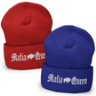 Two knit cuffed beanies on a white background: one red and one royal blue, each with white embroidered Gothic-style text reading 'Mafia Queen' and a white buffalo graphic.