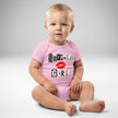 Baby wearing pink mean girl energy parody-style baby bodysuit featuring magazine cutout lettering design and red lips graphic, front view cute fashion inspired baby outfit.