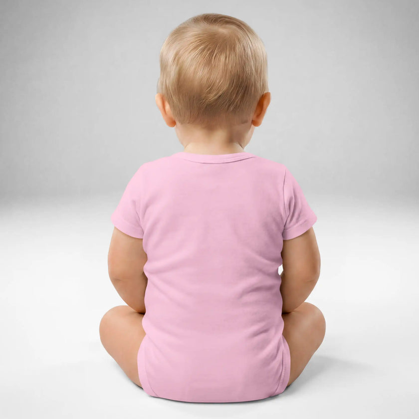 Back view of baby wearing pink mean girl energy baby bodysuit with soft cotton fit and snap closure design, stylish graphic baby apparel.