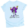 Blue “It’s Giving Mid-Life Crisis” t-shirt flat lay with dancing skeleton in fur coat holding drinks, playful and humorous aging birthday tee