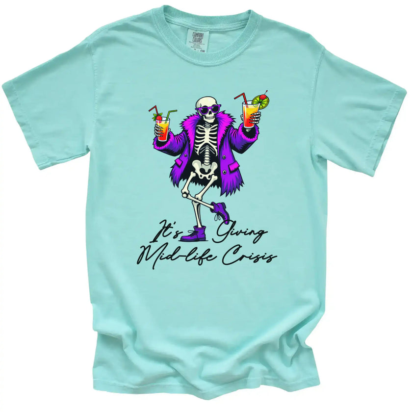 Mint “It’s Giving Mid-Life Crisis” t-shirt flat lay featuring skeleton dancing with tropical drinks, fun sarcastic milestone birthday design