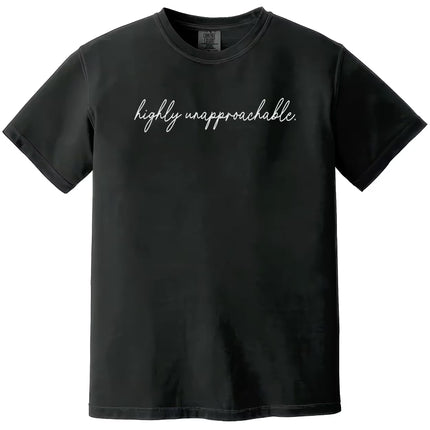 Black “Highly Unapproachable” t-shirt flat lay showcasing elegant script lettering and bold sarcastic text