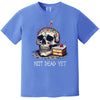 Blue “Not Dead Yet” t-shirt flat lay featuring birthday skull with candle, sprinkles, and cake slice, playful sarcastic graphic tee