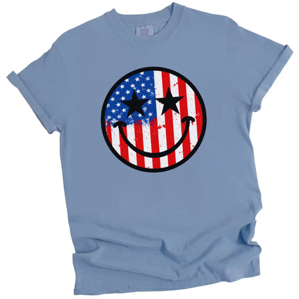 Patriotic paint splatter flag t-shirt in blue, smiling face design with star eyes, fun and casual July 4th graphic tee.