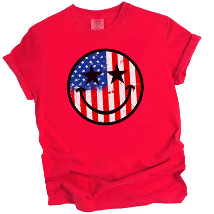 Patriotic smiling face t-shirt in red, American flag paint splatter design with star-shaped eyes, fun July 4th graphic tee