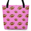 Pretty pink football tote bag featuring an all-over pattern of brown footballs in alternating sizes, stylish reusable shopping bag for everyday errands.