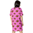 Back view of woman wearing pink oversized sleepwear with repeating brown football pattern in alternating sizes and playful all-over print.