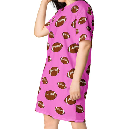 Woman posing in pink football print oversized nightwear featuring alternating large and small brown football pattern in soft relaxed fit.