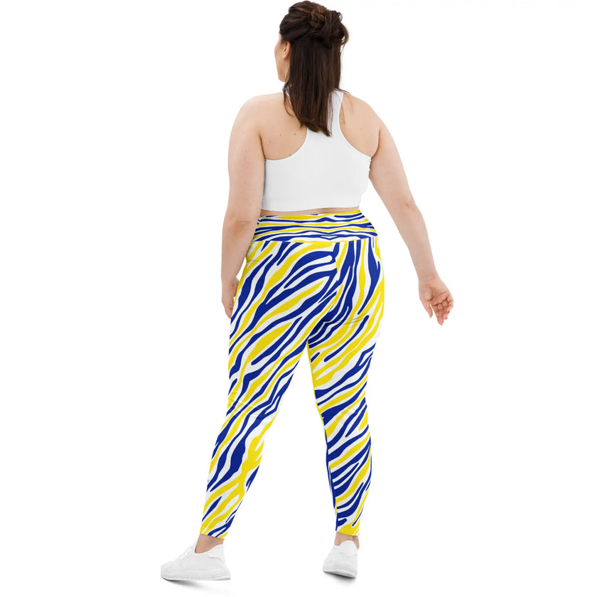 Woman standing from behind view in plus size blue and gold Buffalo leggings, showing the comfortable stretch fit and vibrant hockey fan pattern