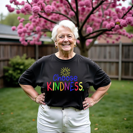 Model wearing black “Choose Kindness” t-shirt in a casual lifestyle garden backyard setting, showing cheerful, positive, and approachable energy