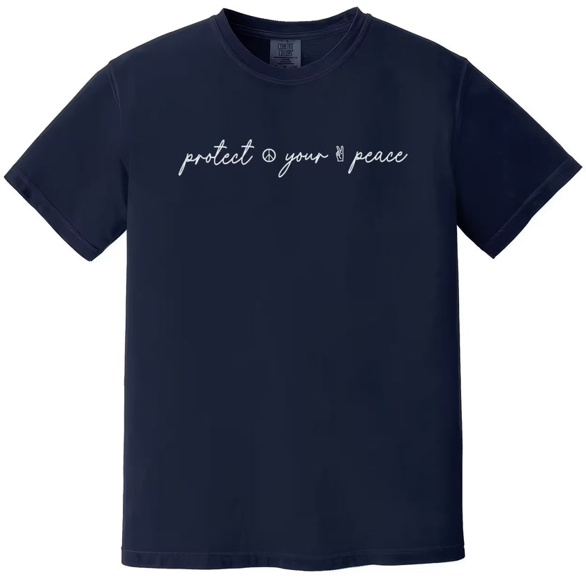 Navy “Protect Your Peace” t-shirt flat lay featuring fancy script font and small peace signs, perfect for everyday casual wear