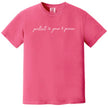 Pink “Protect Your Peace” t-shirt flat lay combining elegant script lettering with minimalist peace icons for soft, calming style