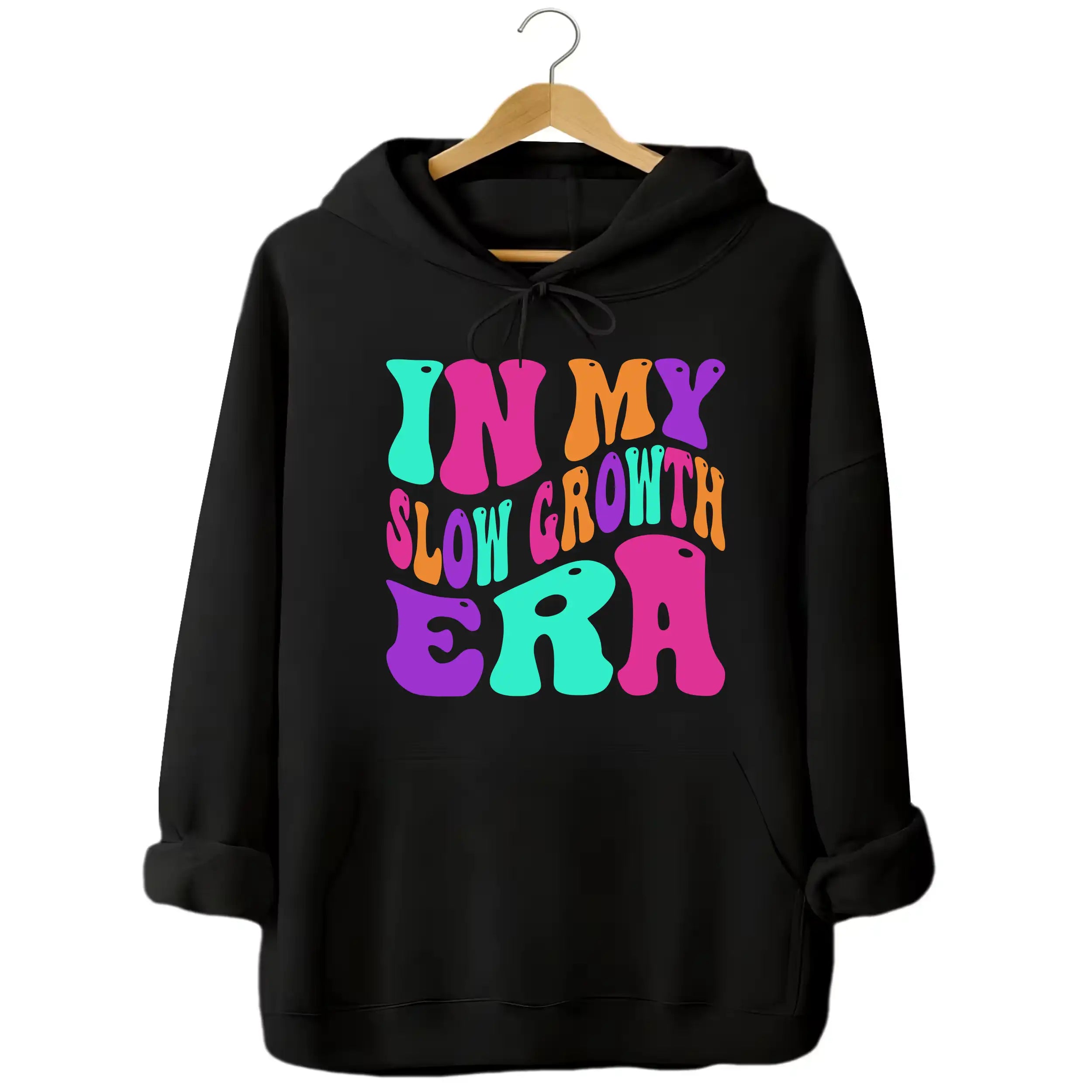 Black “In My Slow Growth Era” hoodie featuring colorful retro neon text, positive mindset design for relaxed, confidence-forward style