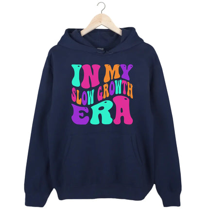 Navy “In My Slow Growth Era” hoodie with bold neon retro lettering, uplifting message for women focused on growth at their own pace