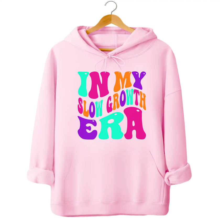 Pink “In My Slow Growth Era” hoodie with bright neon retro lettering, uplifting vibe for women embracing personal growth and cozy everyday wear