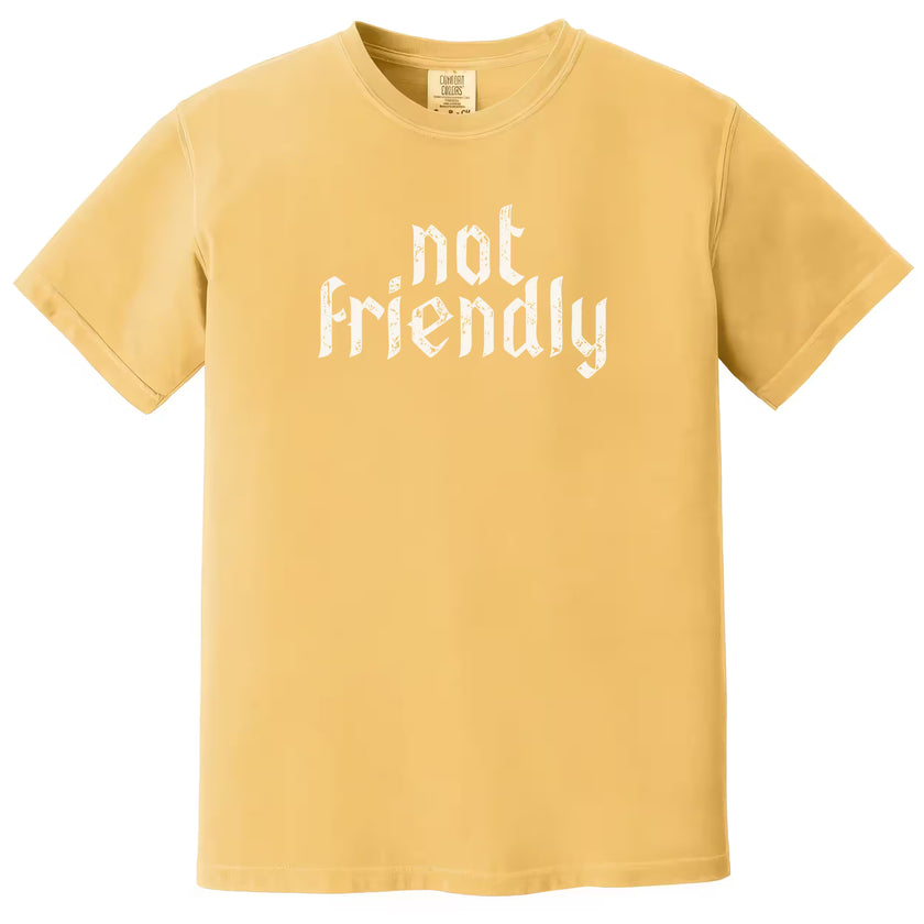 Yellow “Not Friendly” t-shirt flat lay with distressed gothic lettering and simple sarcastic message