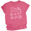 Seashell summer t-shirt in pink, featuring detailed ocean shell varieties arranged in a soft feminine coastal aesthetic layout.