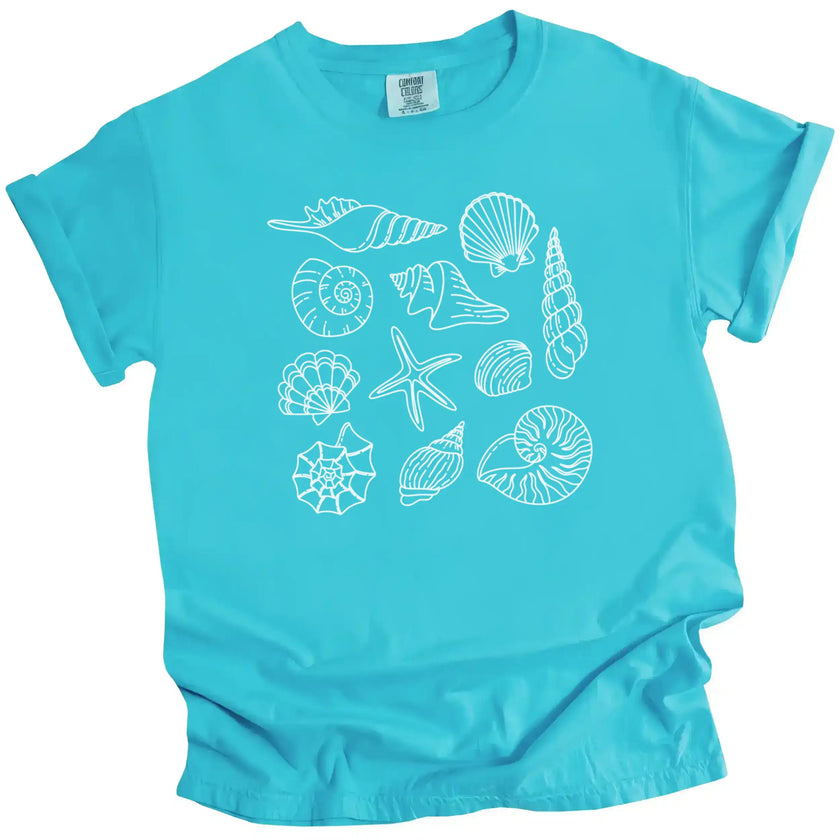 Women’s seashell summer tee in bright blue aqua color, ocean shell illustrations arranged in a minimalist coastal beach aesthetic design.