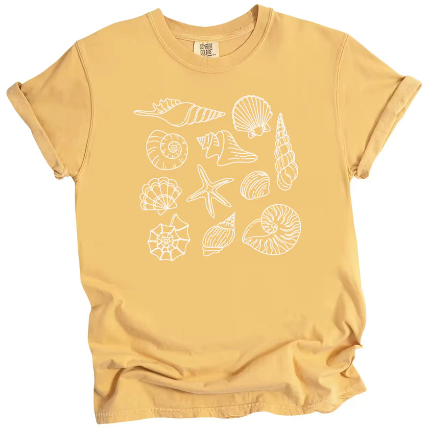 Seashell beach graphic tee in yellow, featuring multiple seashell varieties arranged in a clean coastal summer design for women.