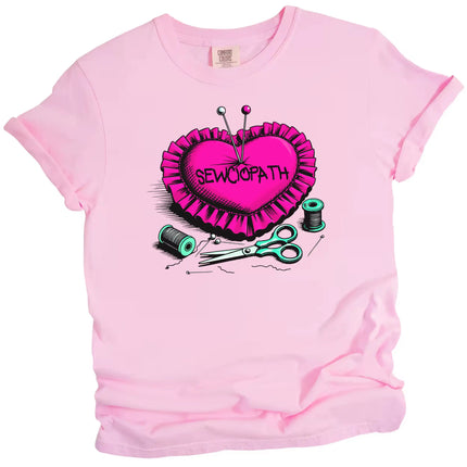 Cute sewing graphic tee in pink, hot pink pincushion with pins, spools, and scissors, ‘Sewciopath’ pun design.