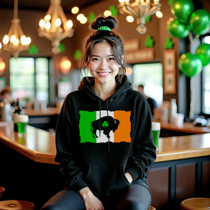Female model wearing black Buffalo Irish flag hoodie sitting at a bar, celebrating St. Patrick’s Day in style