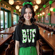 Female model wearing black Buffalo St. Patrick’s Day BUF t-shirt standing at a bar celebrating with drinks