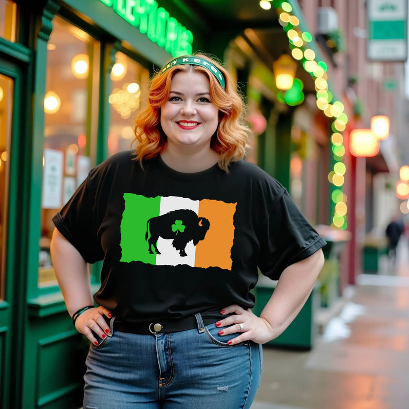 Female model wearing black Buffalo Irish flag St. Patrick’s Day t-shirt standing outside in front of an Irish pub