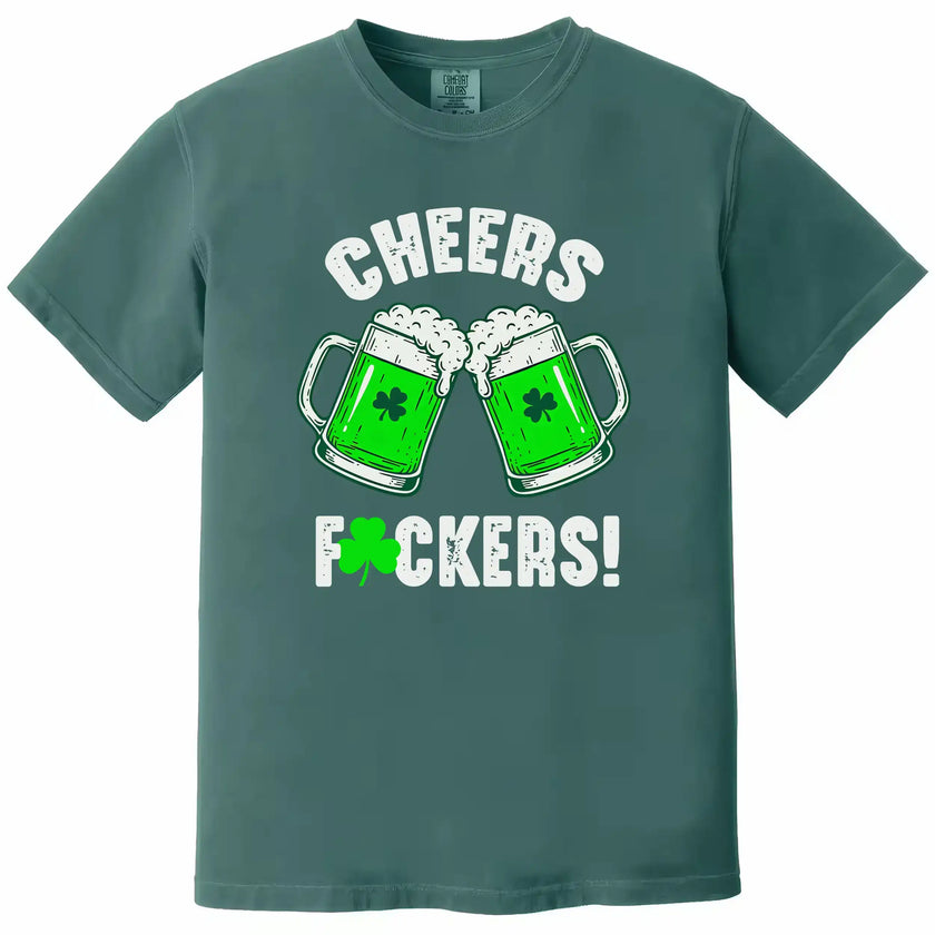 Blue-green St. Patrick’s Day “Cheers Fuckers!” t-shirt flat lay showcasing festive beer mugs and playful holiday lettering
