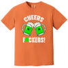 Orange “Cheers Fuckers!” St. Patrick’s Day t-shirt flat lay highlighting playful green beer mugs and festive shamrock accent