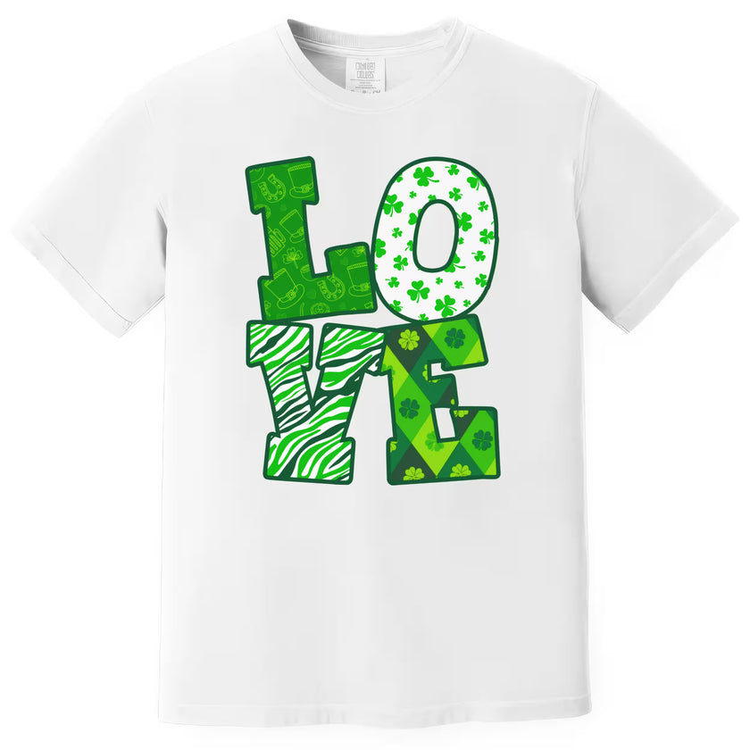 White St. Patrick’s Day LOVE t-shirt flat lay highlighting bold green patterned letters for a clean holiday look