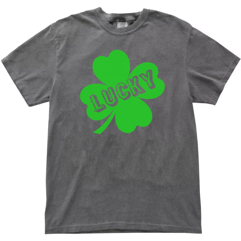 Gray Lucky St. Patrick’s Day t-shirt flat lay showcasing a prominent four-leaf clover and playful distressed lettering