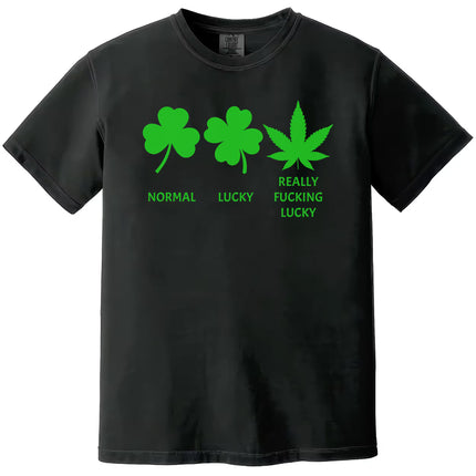 Black St. Patrick’s Day “Really Fucking Lucky” t-shirt flat lay with bold icon design showing shamrock, clover, and cannabis leaf