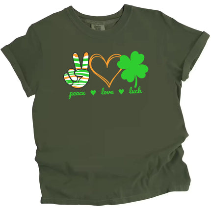 Green St. Patrick’s Day Peace, Love, Luck t-shirt flat lay featuring a peace sign hand, orange hearts, and a green four-leaf clover