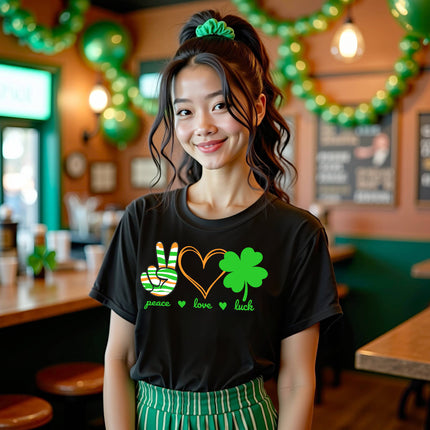 Female model wearing black Peace, Love, Luck St. Patrick’s Day t-shirt standing at the bar celebrating the holiday