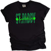 Black St. Paddy Baddie t-shirt flat lay featuring bold green text and high-contrast festive lettering