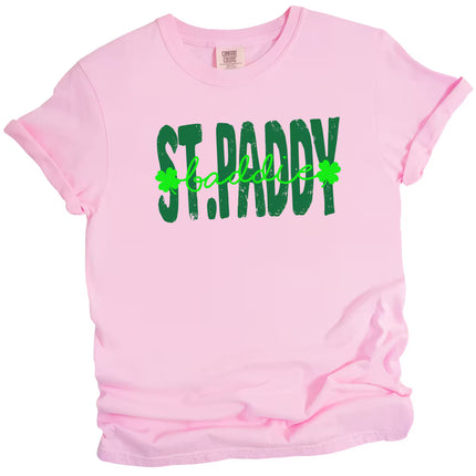 Pink St. Paddy Baddie t-shirt flat lay showcasing fun contrast lettering with bold green accents for a playful holiday look